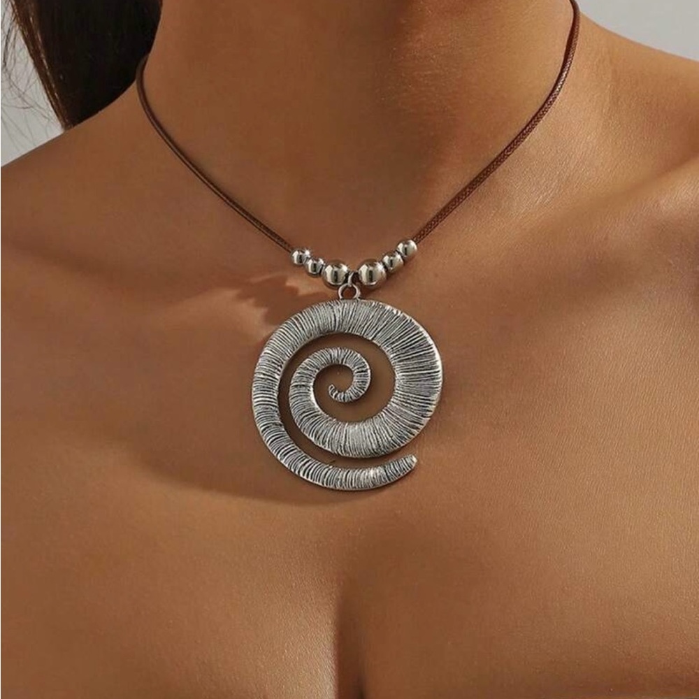 Spiral silver tone necklace with brown leather cord
